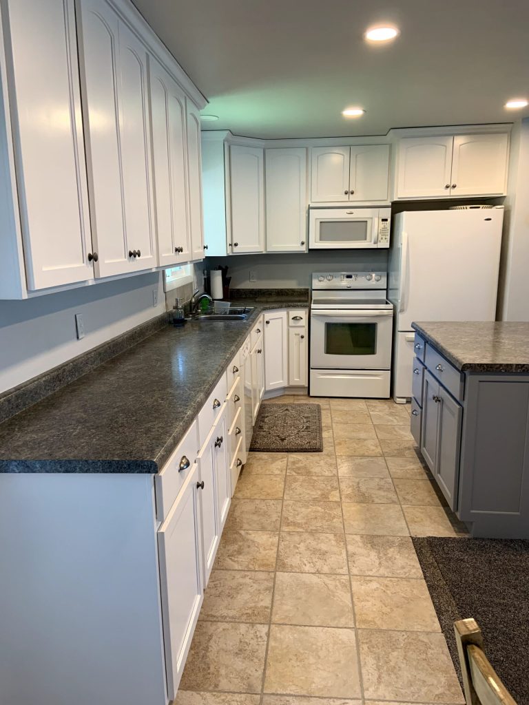 Cabinet repaint with modern black hardware in Castle Rock kitchen